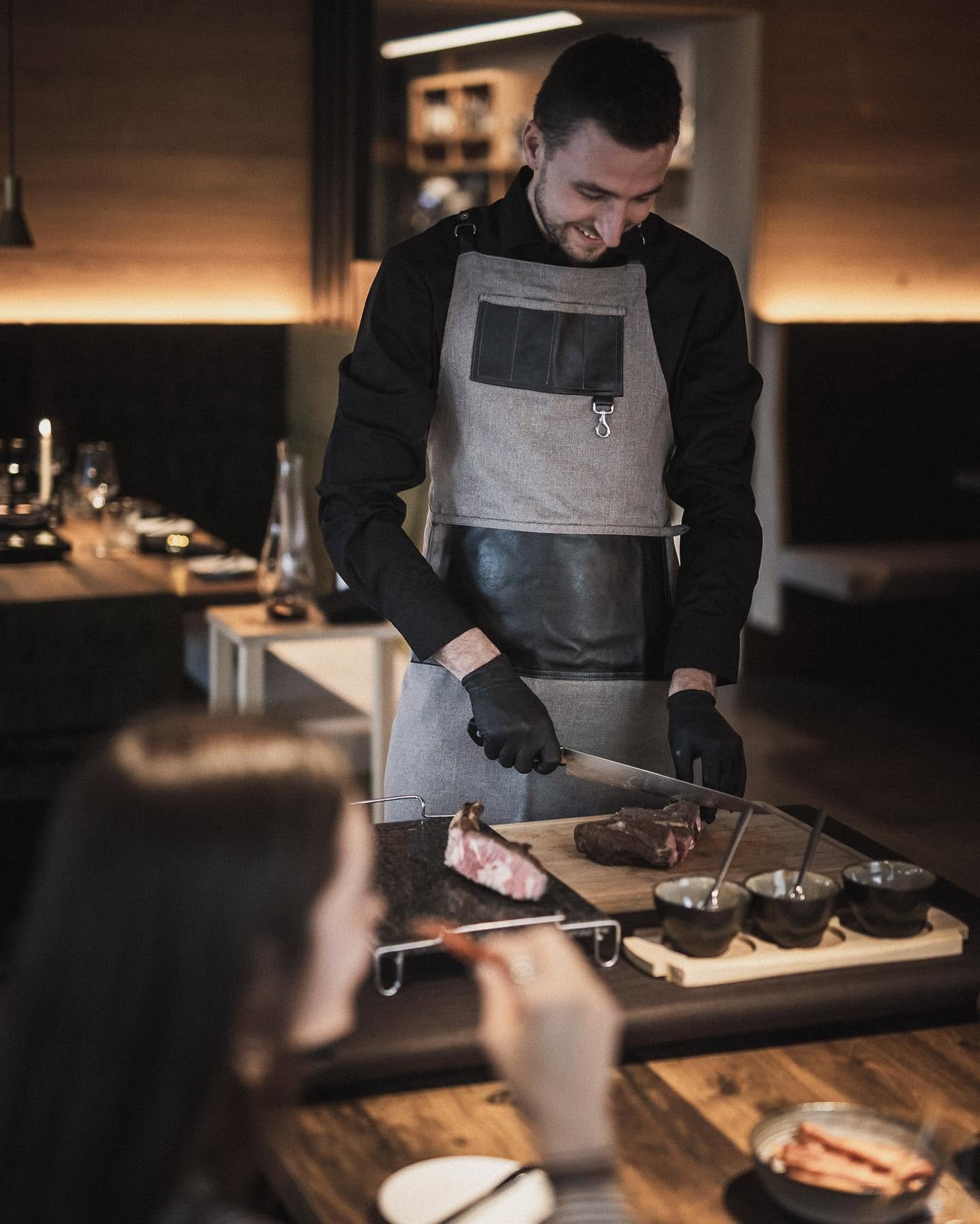 Chef Moritz Leitner carving prime dry-aged steak at Moretto's Steakhouse